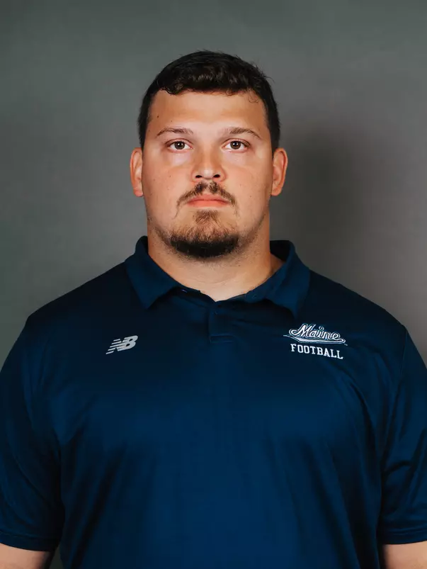 2026 Maine football roster head shot. Blue polo with Maine script.
