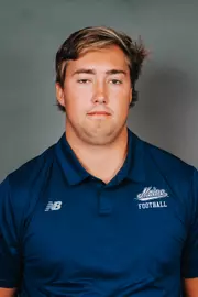 2026 Maine football roster head shot. Blue polo with Maine script.