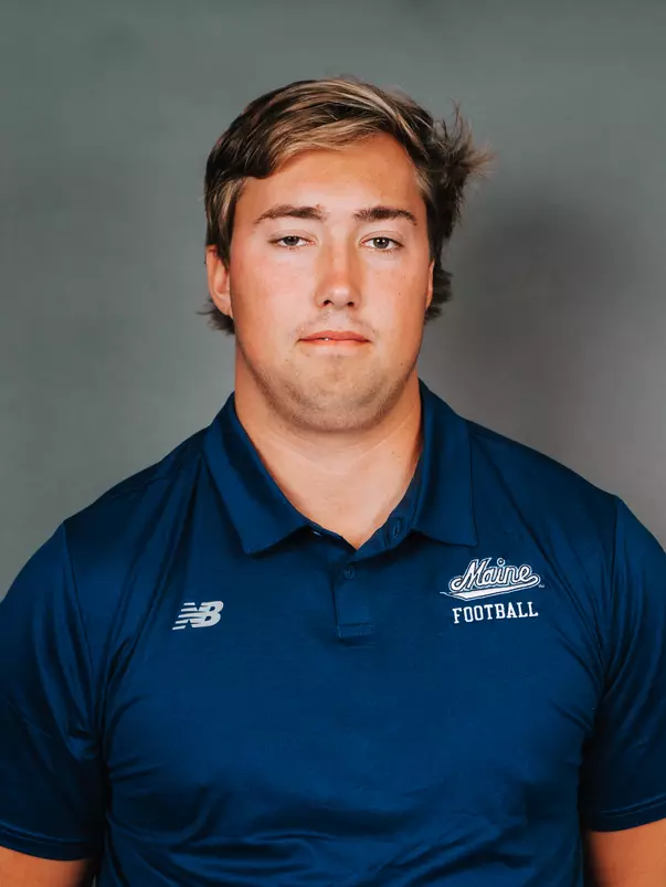 2026 Maine football roster head shot. Blue polo with Maine script.