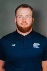 2026 Maine football roster head shot. Blue polo with Maine script.