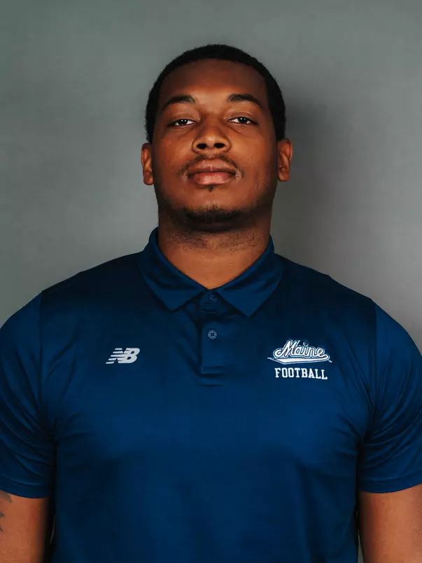 2026 Maine football roster head shot. Blue polo with Maine script.