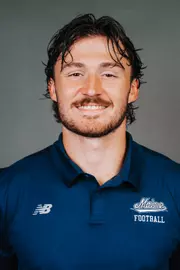 2026 Maine football roster head shot. Blue polo with Maine script.