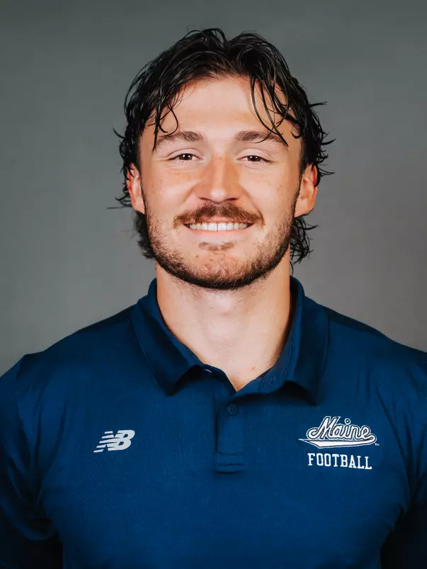 2026 Maine football roster head shot. Blue polo with Maine script.