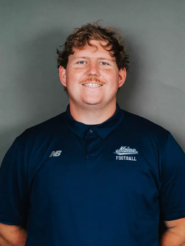 2026 Maine football roster head shot. Blue polo with Maine script.