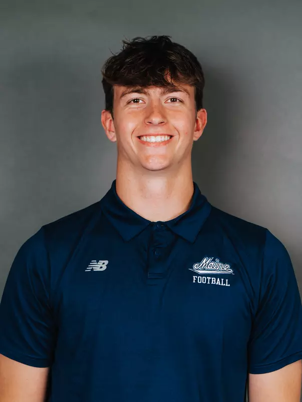 2026 Maine football roster head shot. Blue polo with Maine script.