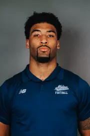 2026 Maine football roster head shot. Blue polo with Maine script.