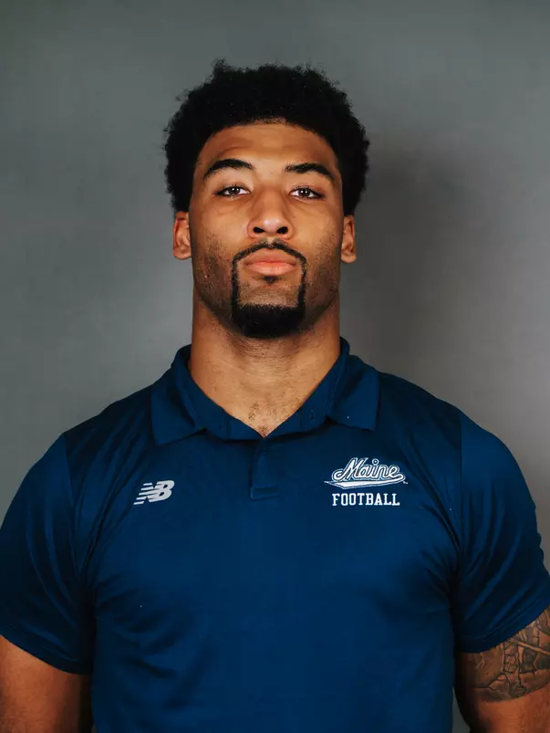 2026 Maine football roster head shot. Blue polo with Maine script.