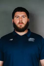 2026 Maine football roster head shot. Blue polo with Maine script.