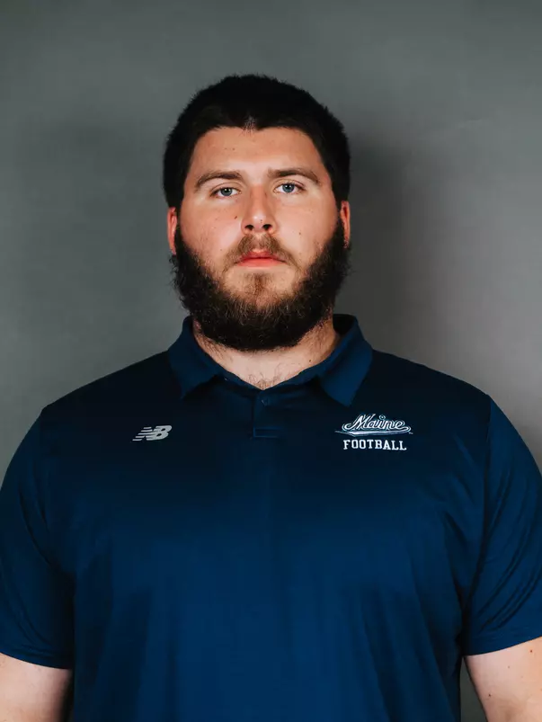 2026 Maine football roster head shot. Blue polo with Maine script.