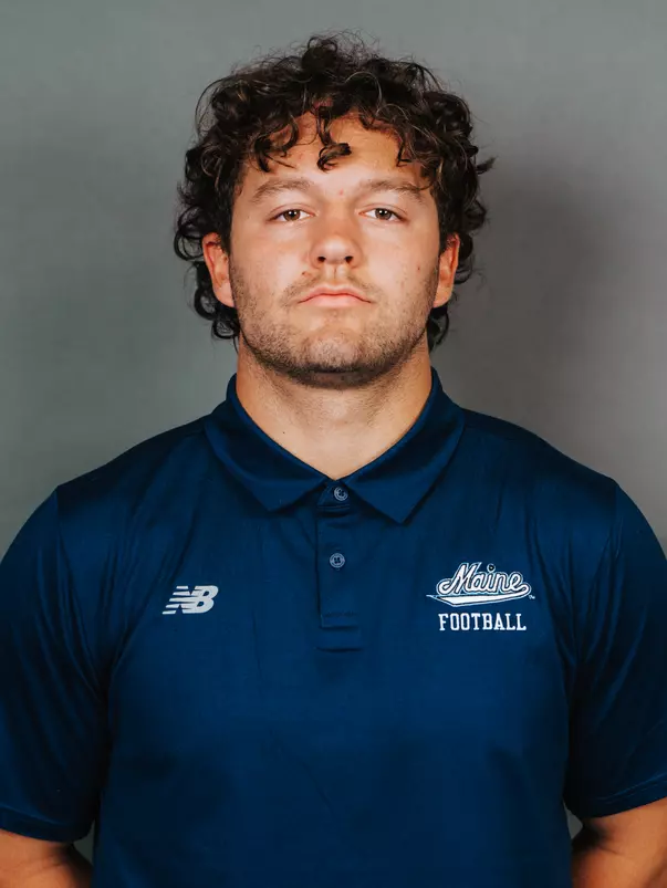 2026 Maine football roster head shot. Blue polo with Maine script.