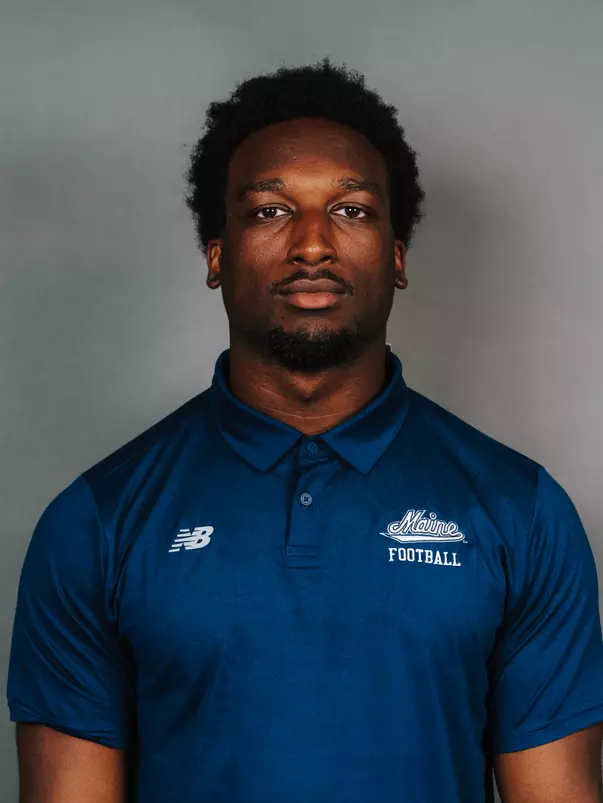 2026 Maine football roster head shot. Blue polo with Maine script.