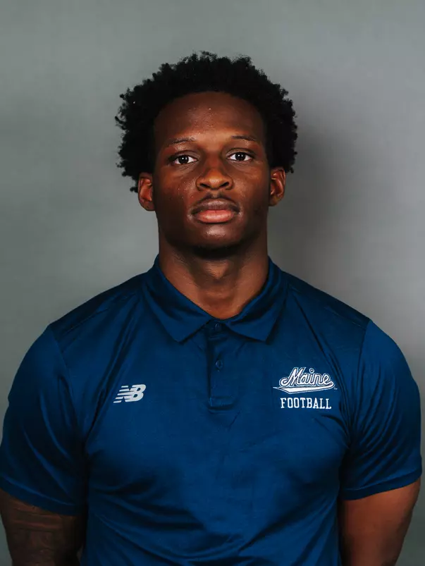 2026 Maine football roster head shot. Blue polo with Maine script.