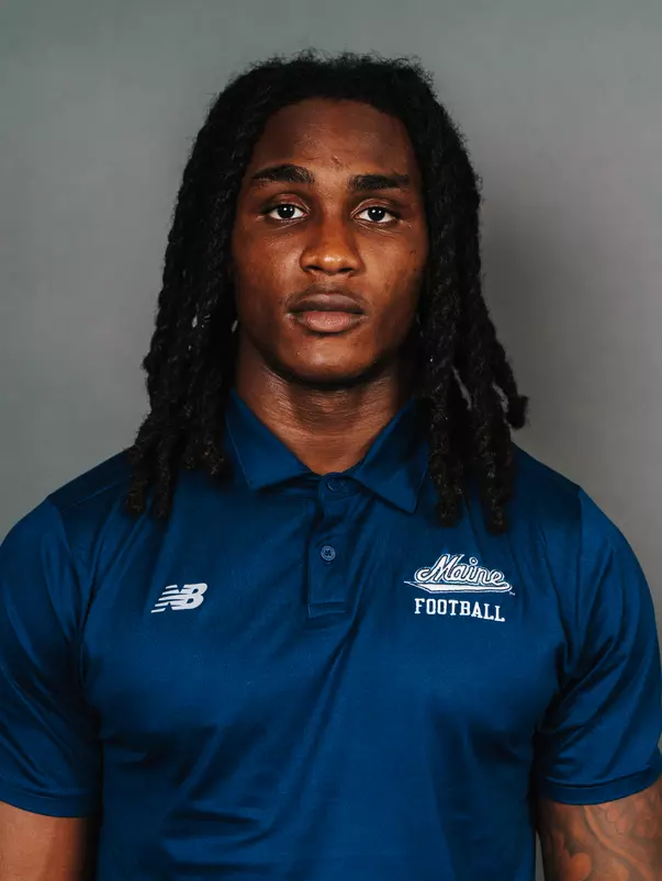 2026 Maine football roster head shot. Blue polo with Maine script.
