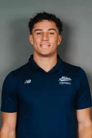 2026 Maine football roster head shot. Blue polo with Maine script.
