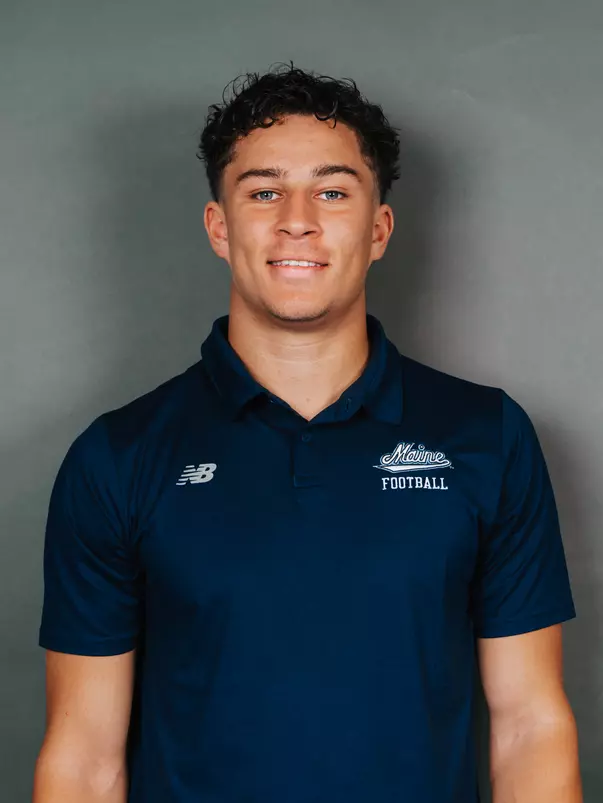 2026 Maine football roster head shot. Blue polo with Maine script.