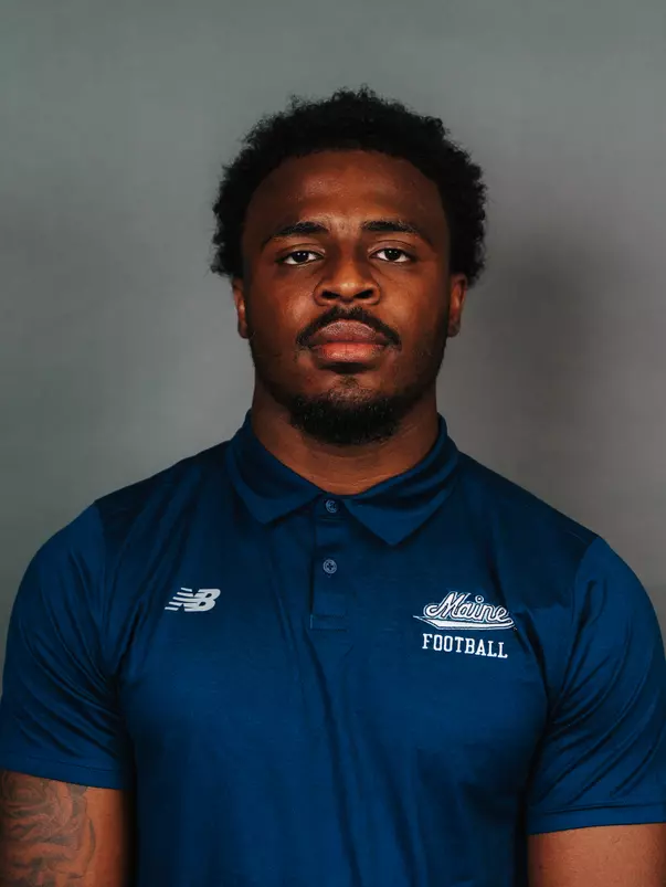 2026 Maine football roster head shot. Blue polo with Maine script.