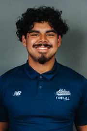 2026 Maine football roster head shot. Blue polo with Maine script.