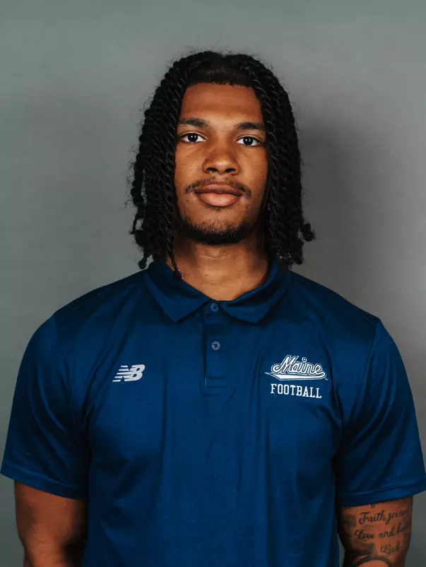2026 Maine football roster head shot. Blue polo with Maine script.