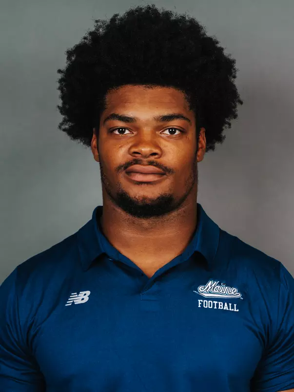 2026 Maine football roster head shot. Blue polo with Maine script.