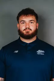 2026 Maine football roster head shot. Blue polo with Maine script.
