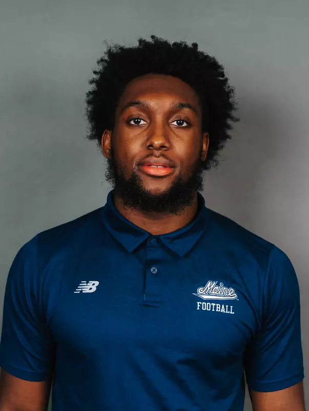 2026 Maine football roster head shot. Blue polo with Maine script.
