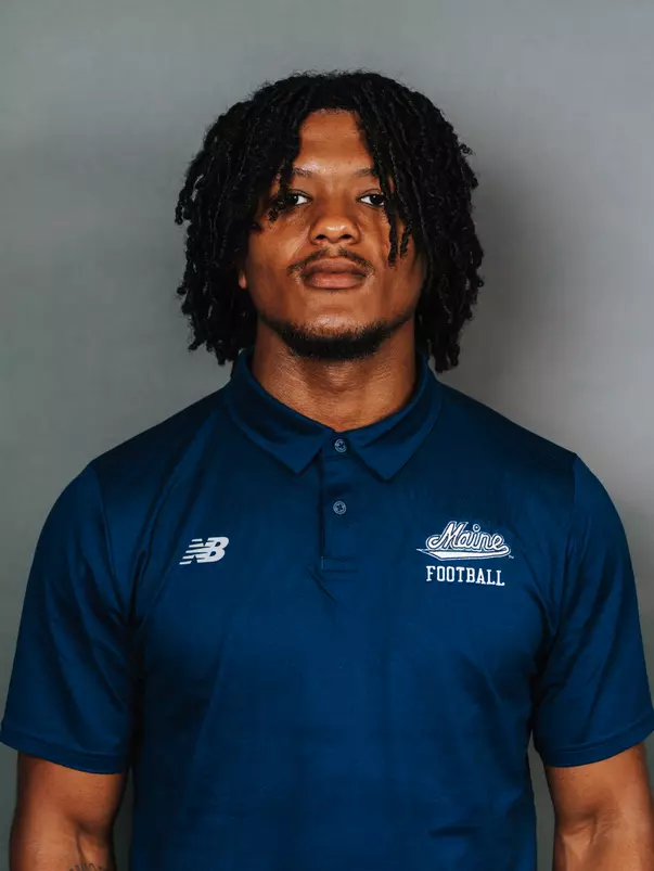 2026 Maine football roster head shot. Blue polo with Maine script.