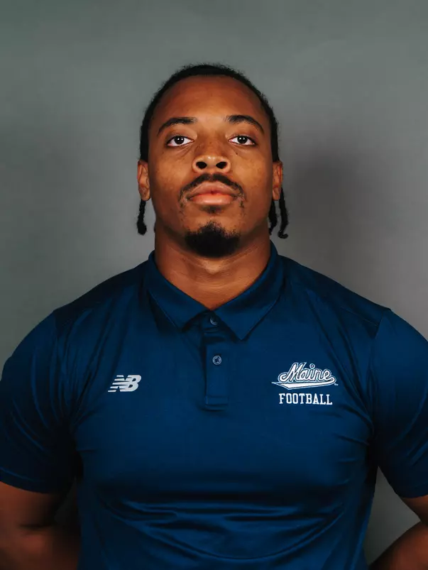 2026 Maine football roster head shot. Blue polo with Maine script.