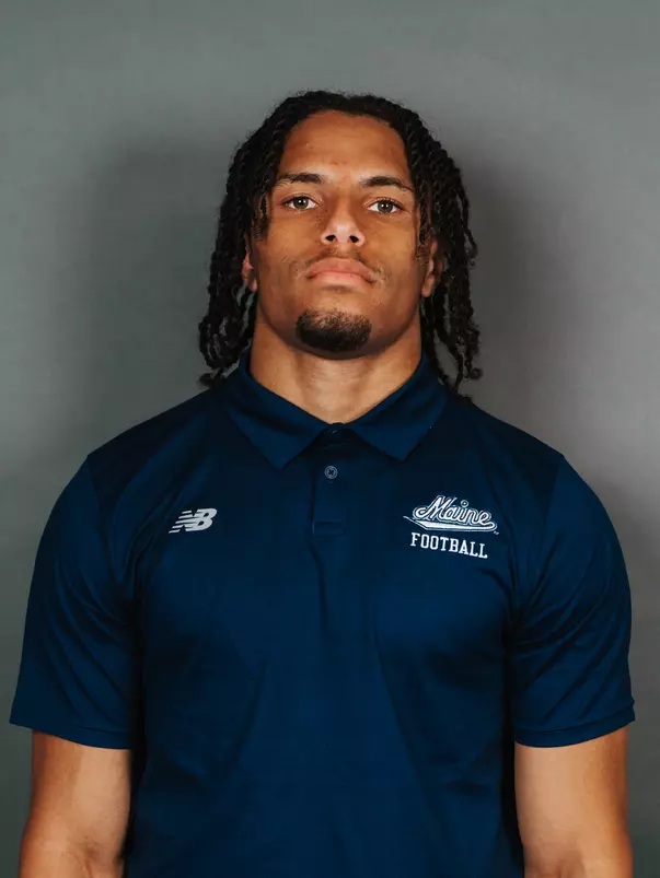 2026 Maine football roster head shot. Blue polo with Maine script.