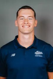2026 Maine football roster head shot. Blue polo with Maine script.