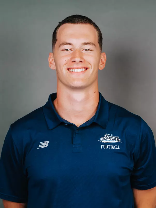 2026 Maine football roster head shot. Blue polo with Maine script.
