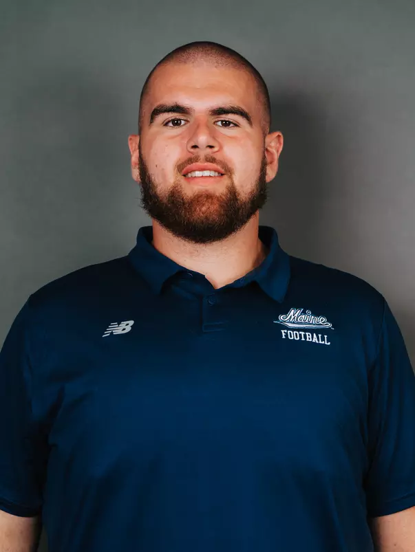 2026 Maine football roster head shot. Blue polo with Maine script.