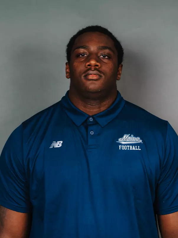 2026 Maine football roster head shot. Blue polo with Maine script.