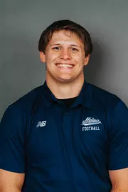2026 Maine football roster head shot. Blue polo with Maine script.
