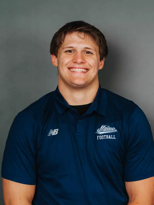 2026 Maine football roster head shot. Blue polo with Maine script.