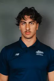 2026 Maine football roster head shot. Blue polo with Maine script.