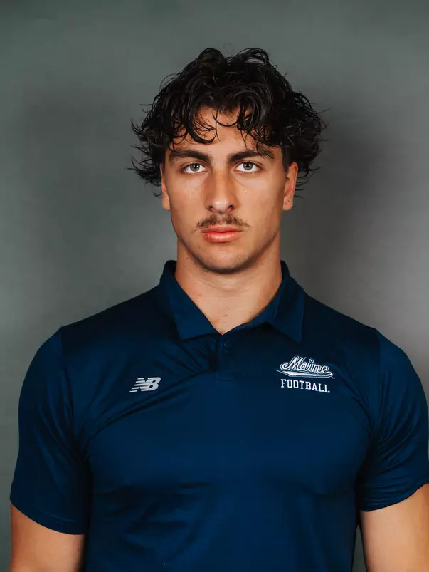2026 Maine football roster head shot. Blue polo with Maine script.