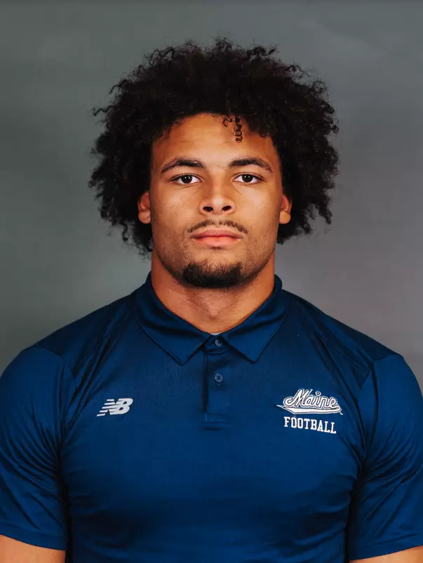 2026 Maine football roster head shot. Blue polo with Maine script.