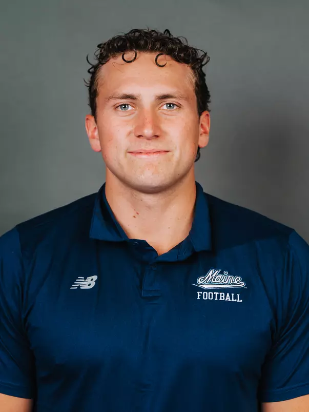 2026 Maine football roster head shot. Blue polo with Maine script.