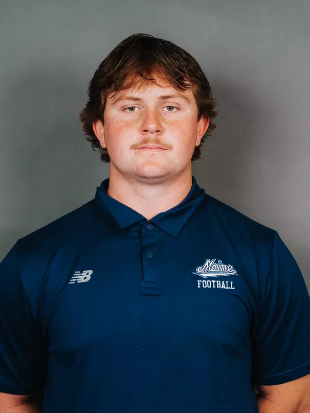 2026 Maine football roster head shot. Blue polo with Maine script.