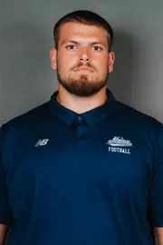 2026 Maine football roster head shot. Blue polo with Maine script.
