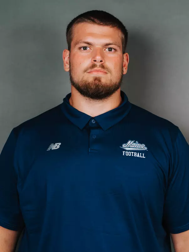 2026 Maine football roster head shot. Blue polo with Maine script.