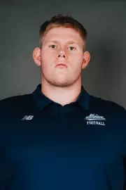2026 Maine football roster head shot. Blue polo with Maine script.
