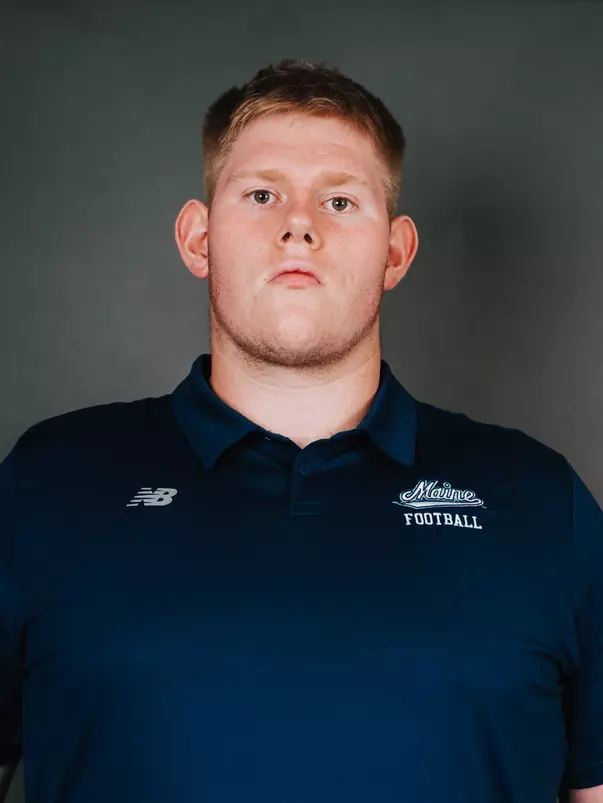 2026 Maine football roster head shot. Blue polo with Maine script.