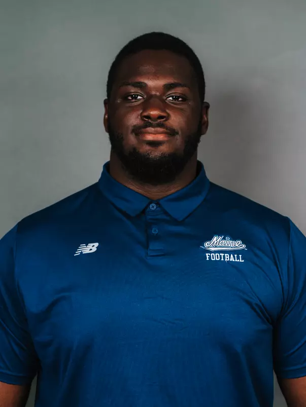 2026 Maine football roster head shot. Blue polo with Maine script.