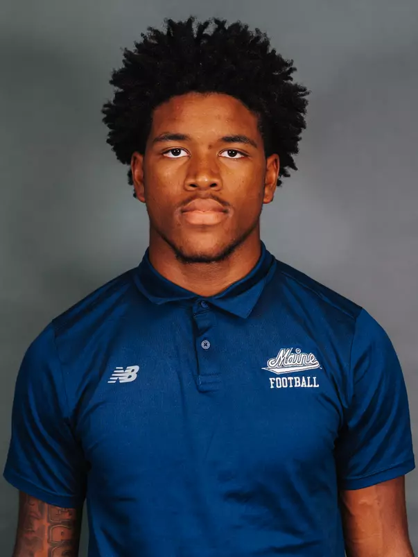 2026 Maine football roster head shot. Blue polo with Maine script.