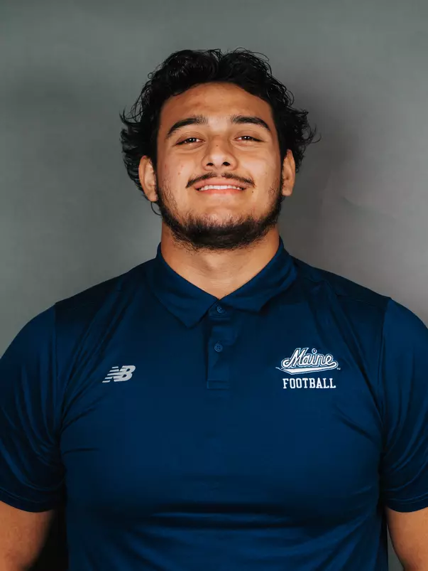 2026 Maine football roster head shot. Blue polo with Maine script.