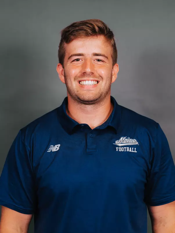 2026 Maine football roster head shot. Blue polo with Maine script.