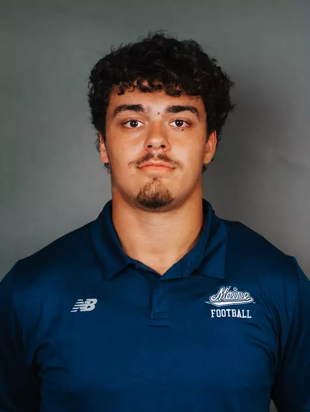 2026 Maine football roster head shot. Blue polo with Maine script.