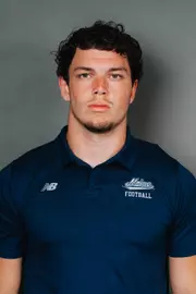 2026 Maine football roster head shot. Blue polo with Maine script.