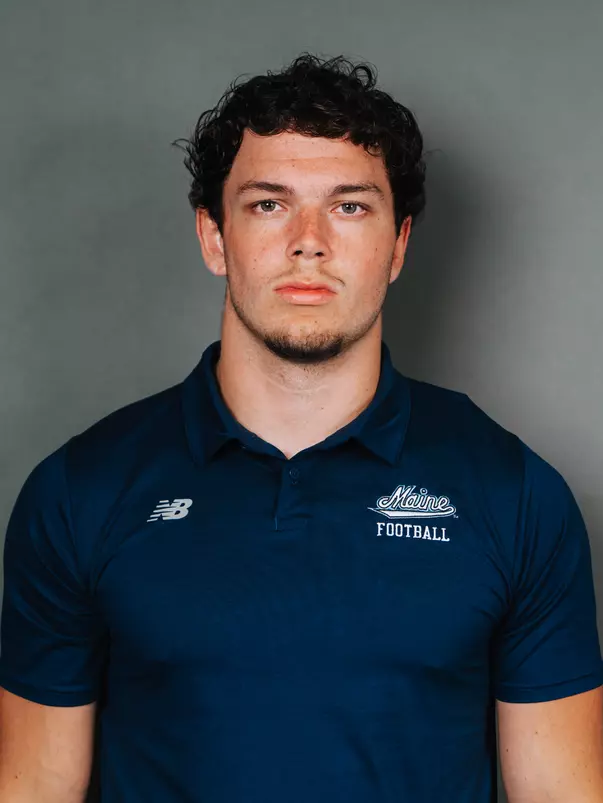 2026 Maine football roster head shot. Blue polo with Maine script.